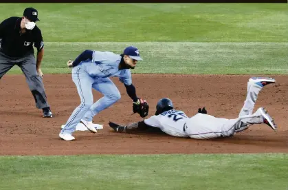  ?? JEFFREY T. BARNES AP ?? The Marlins’ Lewis Brinson beats the tag from Blue Jays second baseman Cavan Biggio during the fourth inning of Tuesday’s game at Buffalo.