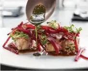  ?? Yi-Chin Lee / Staff photograph­er ?? Reef ’s grilled cobia with shaved beet salad and XO sauce features chef Bryan Caswell’s beloved Gulf Coast catch.