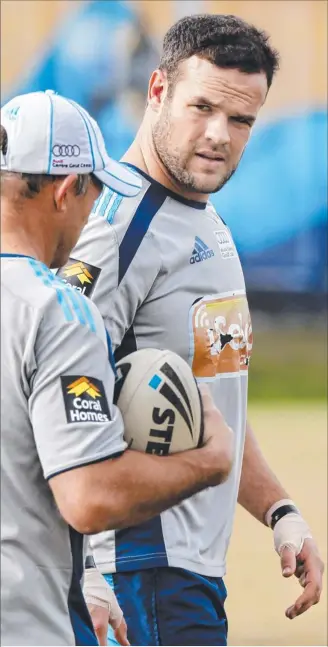  ??  ?? Nate Myles works with Titans assistant coach Trevor Gillmeiste­r at training.