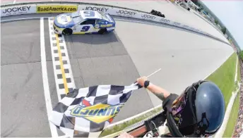  ?? LOGAN RIELY/GETTY IMAGES ?? Chase Elliott takes the checkered flag Sunday at the NASCAR Cup Series race.