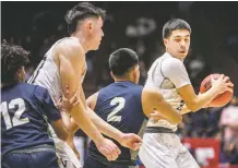  ?? JAVIER GALLEGOS/THE NEW MEXICAN ?? Volcano Vista’s Kenyon Aguino, right, is guarded by Artisco Heritage players Wednesday during a 5A quarterfin­al in The Pit.