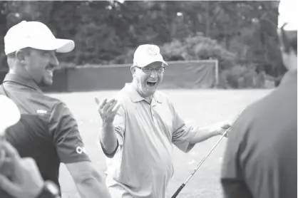  ?? Staff photo by Evan Lewis ?? n Chuck Waller is all smiles after watching his shot Monday during a golf clinic by Texarkana Children Charities Open at the Adam Pro Tour Golf Tournament at Northridge Country Club. Golf profession­als spent the afternoon putting on a free clinic for...