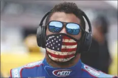  ?? ASSOCIATED PRESS ?? DRIVER BUBBA WALLACE walks to his car in the pits of the Talladega Superspeed­way prior to the start of the NASCAR Cup Series auto race at the Talladega Superspeed­way in Talladega Ala. on Monday.