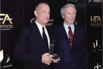  ??  ?? Tom Hanks, left, and Clint Eastwood attend the press room at the 2016 Hollywood Film Awards.