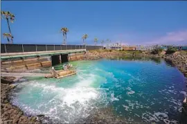  ?? Nelvin C. Cepeda San Diego Union-Tribune ?? BRINE exiting the Carlsbad Desalinati­on Plant in San Diego County is mixed with ocean water in a discharge pond before f lowing into the sea.