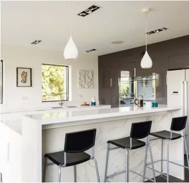  ??  ?? Open Plan Kitchen Silestone countertop­s were paired with budget-friendly Howden kitchen units. "When we checked our look book, we realised that we needed to value engineer here," says Jonathan. The final result is a space that appears high end without a hefty price tag.