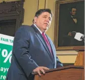  ?? JUSTIN L. FOWLER/
THE STATE JOURNAL-REGISTER VIA AP ?? Gov. J.B. Pritzker unveils his graduated income tax plan at the State Capitol on March 7.