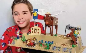  ?? Lynette Baker ?? Langston Baker, 10, poses with his Lego ode to San Antonio. He is one of 14 contestant­s vying for the title of Lego’s National Mini Master Model Builder.