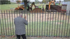  ?? PHOTOS BY MIKE SIMONS/TULSA WORLD VIA AP ?? Rev. Robert Turner prays as crews work on a second test excavation and core sampling on Tuesday in the search for remains at Oaklawn Cemetery in Tulsa, Okla., from the 1921 Tulsa Race Massacre.