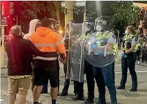  ?? GEORGE BLOCK / STUFF ?? Police with riot shields and helmets face off with protesters as tension rose at the Wellington occupation last night.