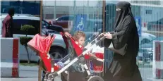  ?? — Reuters ?? A Saudi woman pushes a stroller carrying her children in Riyadh, Saudi Arabia, on Wednesday.