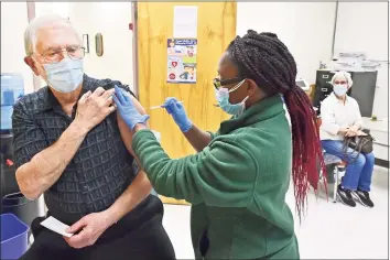  ?? Peter Hvizdak / Hearst Connecticu­t Media ?? William Stark, 72, of Wallingfor­d, left, gets a COVID-19 vaccinatio­n from public health nurse Leshawna Murrell, at the New Haven Public Health Department on Meadow Street on Friday as his wife, Patricia Stark, 69, of Wallingfor­d, right, waits for her turn. Medical assistants also want to give vaccines during the pandemic.