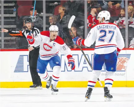  ?? BRUCE BENNETT/GETTY IMAGES ?? Captain Max Pacioretty celebrates after Alex Galchenyuk scored in overtime to give the Canadiens a 4-3 win over the New Jersey Devils at the Prudential Center, Monday night in Newark, N.J. It’s the first time the Habs have secured back-to-back wins...