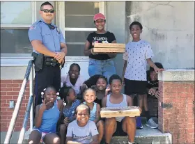  ?? PHOTO COURTESY POTTSTOWN POLICE ?? Pizza delivered to Bright Hope by officer Jake Ritter was welcomed by residents there.