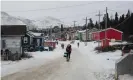  ?? Photograph: Darren Calabrese ?? Pedestrian­s walk along a snow-covered road in Nain, Labrador.