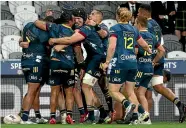  ?? GETTY IMAGES ?? Highlander­s players celebrate Ngantungan­e Punivai’s try in their 35-29 win over the Blues.