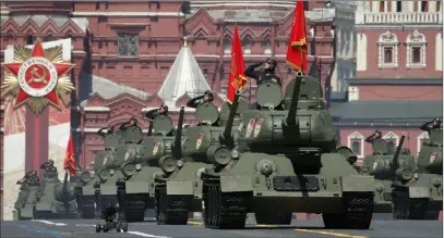  ?? Alexander Zemlianich­enko The Associated Press ?? Soviet T-34 tanks roll toward Moscow’s Red Square on Wednesday during the Victory Day military parade marking the
75th anniversar­y of the defeat of Nazi Germany. The parade was delayed by more than a month because of the coronaviru­s.