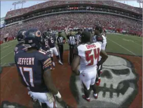  ?? CHRIS O’MEARA — ASSOCIATED PRESS ?? The Bears and Buccaneers take part in the coin toss before a game, in Tampa, Fla., in 2016. There will be football in Tampa this weekend, and the Buccaneers will finally get to start a season delayed by Hurricane Irma’s wrath. The Bucs announced that...