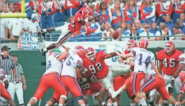  ?? The Florida times-union/tnS ?? Georgia’s Champ Bailey (42) flies high to block an extra point against Florida in the 1996 Florida-Georgia game in Jacksonvil­le.