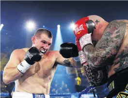  ?? PHOTO: GETTY IMAGES ?? Paul Gallen hits Lucas Browne with a straight left during their heavyweigh­t bout in Wollongong on Wednesday night.