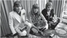  ?? ASSOCIATED PRESS ?? Members of the band Emerson, Lake and Palmer, (from left) Greg Lake, Keith Emerson and Carl Palmer, pose after an award ceremony in 1972.