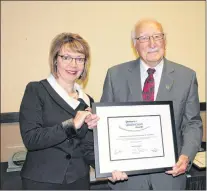  ?? SAM MCNEISH/THE TELEGRAM ?? Augustine (Gus) Etchegary of Portugal Cove-st. Philip’s is presented with a 2017 Seniors of Distinctio­n award Tuesday by Suzanne Brake.