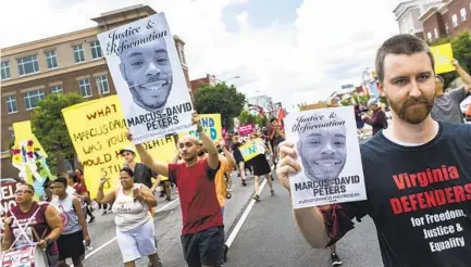  ?? DANIEL SANGJIB MIN AP ?? People marching in support of Marcus-david Peters shout as they head to the Richmond Police Headquarte­rs in Virginia in 2018.