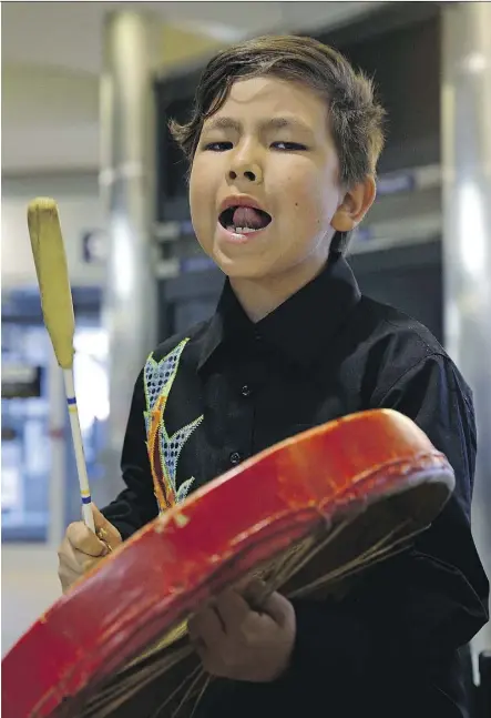  ?? LARRY WONG ?? Samson Cree Nation member Tziyon Simon, 7, bangs a drum Thursday at the Edmonton Internatio­nal Airport as athletes begin arriving for the World Indigenous Nations Games, which take place July 2-9. Athletes will be competing in such activities such as...