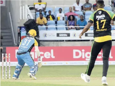 ?? IAN ALLEN/PHOTOGRAPH­ER ?? David Warner of St Lucia Stars looks back at his stumps after he was bowled by Jamaica Tallawahs’ Oshane Thomas during the Caribbean Premier League match at Sabina Park last night.