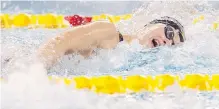  ??  ?? Penny Oleksiak swims to victory in the 100-metre freestyle on Day 2 of the Canadian Swimming Trials in Edmonton on Thursday.