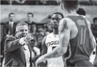  ?? THE ASSOCIATED PRESS ?? Auburn men’s basketball coach Bruce Pearl reacts to an official’s call and receives a technical foul during a home game against Florida last season. Auburn is among the programs caught up in a corruption scandal overshadow­ing the start of a new season.