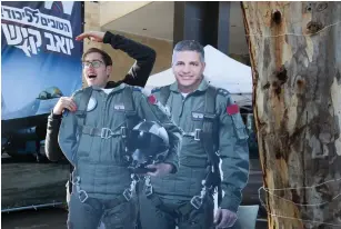  ?? (Marc Israel Sellem/The Jerusalem Post) ?? A LIKUD SUPPORTER checks out MK Yoav Kisch’s cardboard cutout yesterday.