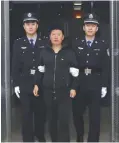  ??  ?? BEIJING: In this photo released by China’s Xinhua News Agency, Yan Yongmin (center) arrives at Capital Internatio­nal Airport in Beijing yesterday. Yan, a former drug company chairman who was on a list of China’s 100 most-wanted fugitives abroad has...