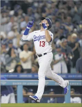  ?? ASHLEY LANDIS — THE ASSOCIATED PRESS ?? The Dodgers’ Max Muncy points to the sky after his third-inning home run Friday night.