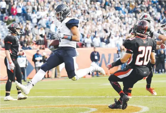  ??  ?? Valor Christian’s Joshia Davis scores with 10 seconds left in the first half Saturday to give the Eagles a 23-7 lead over the Pomona Panthers in the Class 5A championsh­ip game at Sports Authority Field at Mile High. The Eagles went on to win 30-14. Joe...