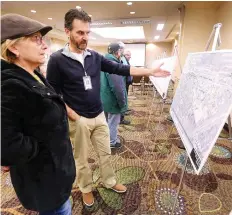  ?? DAN JANISSE ?? Zoran Savic, the city’s contract supervisor for the Huron Church Road project, explains some of the details to Olga Matwijenko, who lives in South Windsor, at an informatio­n session Thursday.