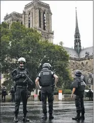  ?? AP/MATTHIEU ALEXANDRE ?? Police officers seal off the access to Notre Dame Cathedral in Paris on Tuesday following an attack.