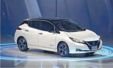  ?? PHOTO BY EUGENE HOSHIKO/AP ?? Nissan’s new Leaf zero-emissions electric vehicle is shown last week during the world premiere in Chiba, near Tokyo. It can travel 150 miles before needing a recharge. It sells for about $31,000.