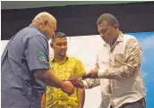  ?? Photo: Vilimoni Vaganalau ?? Atunaisa Rainima receives his award from Prime Minister Voreqe Bainimaram­a at the Grand Pacific Hotel in Suva, on January 11, 2018.