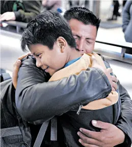  ?? RINGO H.W. CHIU/AP PHOTOS ?? David Xol, of Guatemala, hugs his son Byron last week at Los Angeles Internatio­nal Airport as they reunite after being separated at the border in May 2018. “He grew a lot,” Xol said.