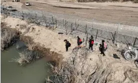  ?? ?? An aerial view of the area as migrants walking along razor wire after crossing the Rio Grande into the US on 28 January 2024 in Eagle Pass, Texas. Photograph: Anadolu/Getty Images