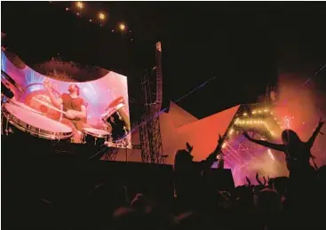  ?? LEON NEAL/GETTY ?? The crowd reacts as the Killers’ drummer Ronnie Vannucci Jr. is seen on screen at Glastonbur­y Festival in 2019.