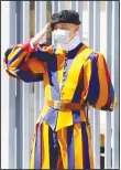  ??  ?? A Swiss Guard stands at the entrance of the Vatican on Monday, May 4. The Vatican is postponing the annual swearing-in ceremony for its new crop of Swiss Guards, a commemorat­ion usually held each May 6 to honor the guardsmen who died while protecting the pope during the 1527 Sack of Rome. The Swiss Guards said Monday that due to the ongoing coronaviru­s emergency, the pomp-filled ceremony will now be held on Oct 4. (AP)