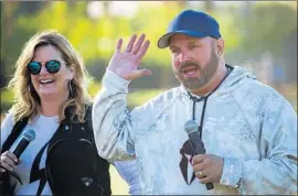  ?? Allen J. Schaben Los Angeles Times ?? TRISHA YEARWOOD and Garth Brooks talk to the media before hitting the stage on the final day of the 2018 Stagecoach Country Music Festival on Sunday.