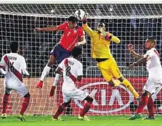  ?? Reuters ?? High flyers Chile’s Alexis Sanchez (left) jumps for the ball as Peru’s goalie Pedro Gallese tries to foil the goal attempt.