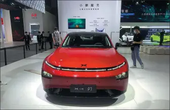  ?? CAO YINGYING / CHINA DAILY ?? Chinese new energy vehicle startup Xpeng displays its P7 model at the 2020 Guangzhou auto show.