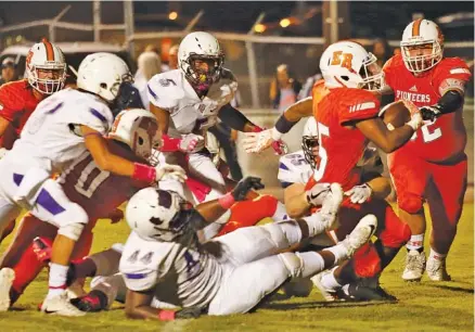  ?? STAFF PHOTO BY DOUG STRICKLAND ?? East Ridge running back Jalen Boykin is tackled in the end zone for a safety by Central’s Drew Goodwin, rear, during the visiting Purple Pounders’ 41-6 region win Friday night at East Ridge.