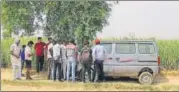  ?? AP PHOTO ?? Villagers gather near the crime scene in a field near Jewar, Greater Noida, on Thursday.