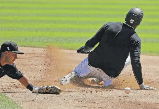  ?? NAM Y. HUH/AP ?? Second baseman Nick Madrigal misses the ball as Luis Robert steals second with an awkward slide during an intrasquad game Tuesday at Guaranteed Rate Field.