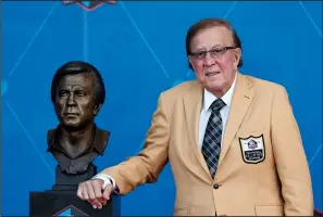  ?? RON SCHWANE-POOL/GETTY IMAGES ?? Tom Flores, a member of the Pro Football Hall of Fame Class of 2021, poses with his bust during the induction ceremony at the Pro Football Hall of Fameat Tom Benson Hall Of Fame Stadium on Sunday in Canton, Ohio.